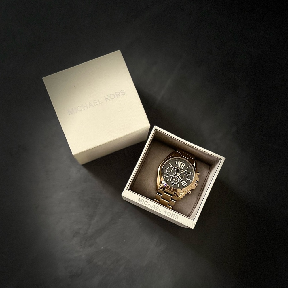 Michael Kors Gold with Black Watch. Brings extra links for sizing of your wrist